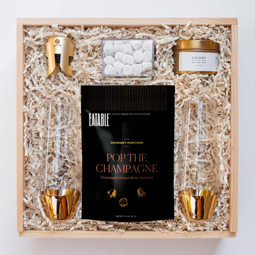 gold champagne flutes with gold champagne stopper and pop the champagne popcorn packaged in wood gift box